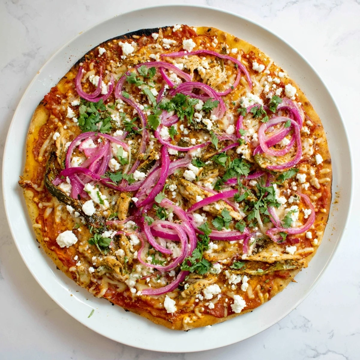 Mexican fusion pizza featuring charred poblano strips and fresh cilantro garnish