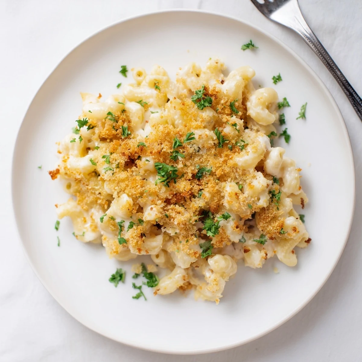 Golden baked mac and cheese with crispy panko topping served in a casserole dish