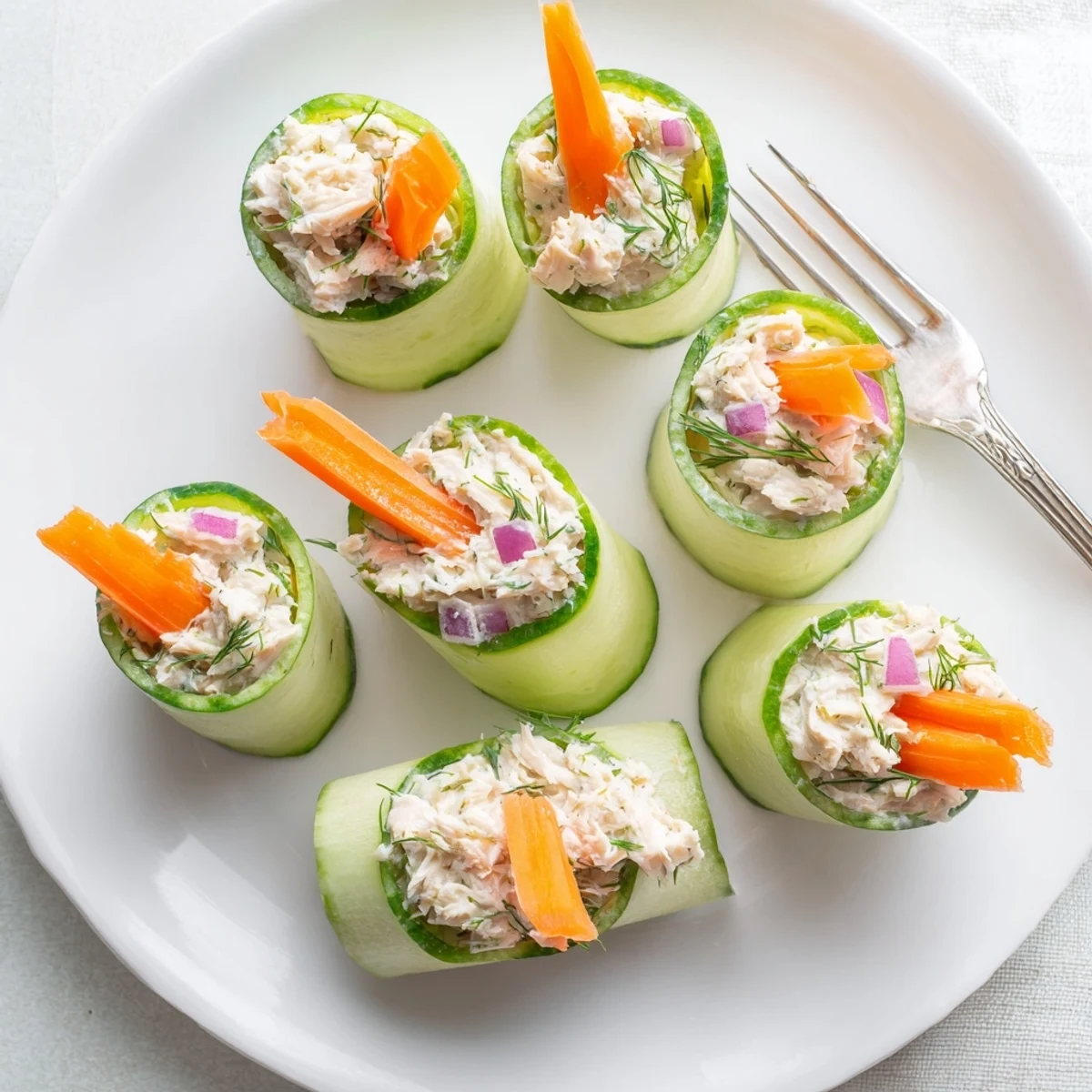 Fresh cucumber ribbons wrapped around creamy chicken salad create a light and refreshing appetizer