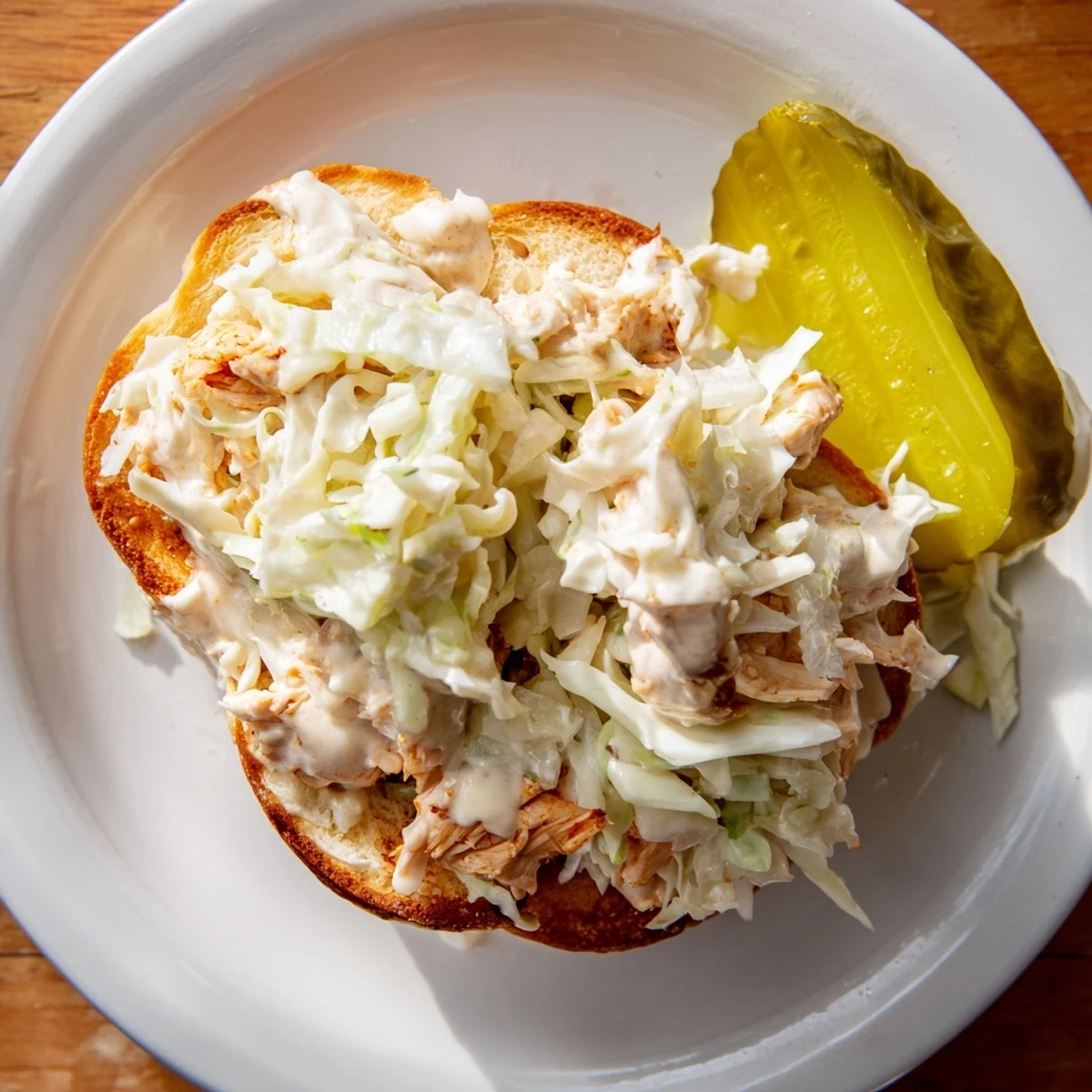 Hearty Alabama BBQ chicken sandwich piled high with crisp coleslaw and tangy white sauce