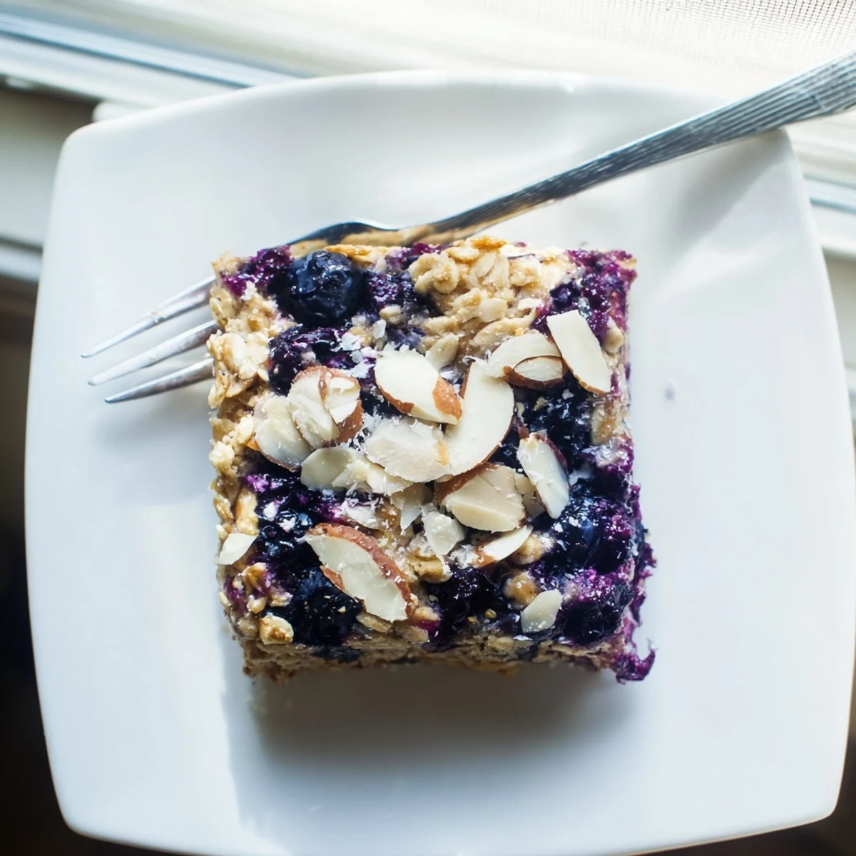Sliced blueberry cottage cheese breakfast bake served warm on a white plate