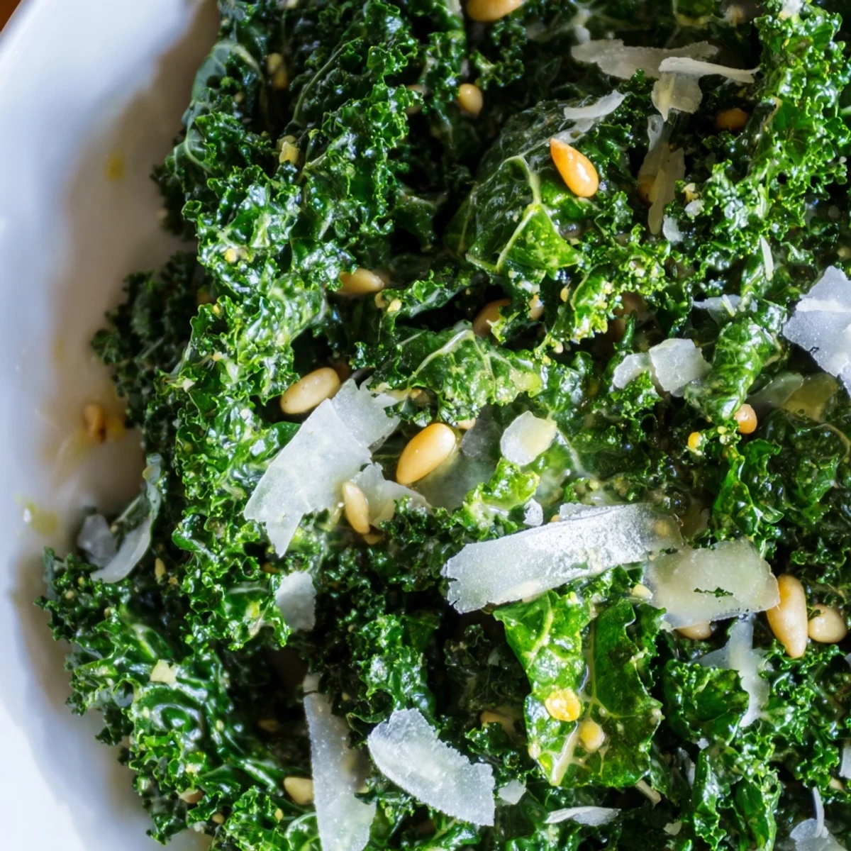 Bright Garlic Lemon Parmesan Kale Salad with toasted pine nuts and shaved cheese
