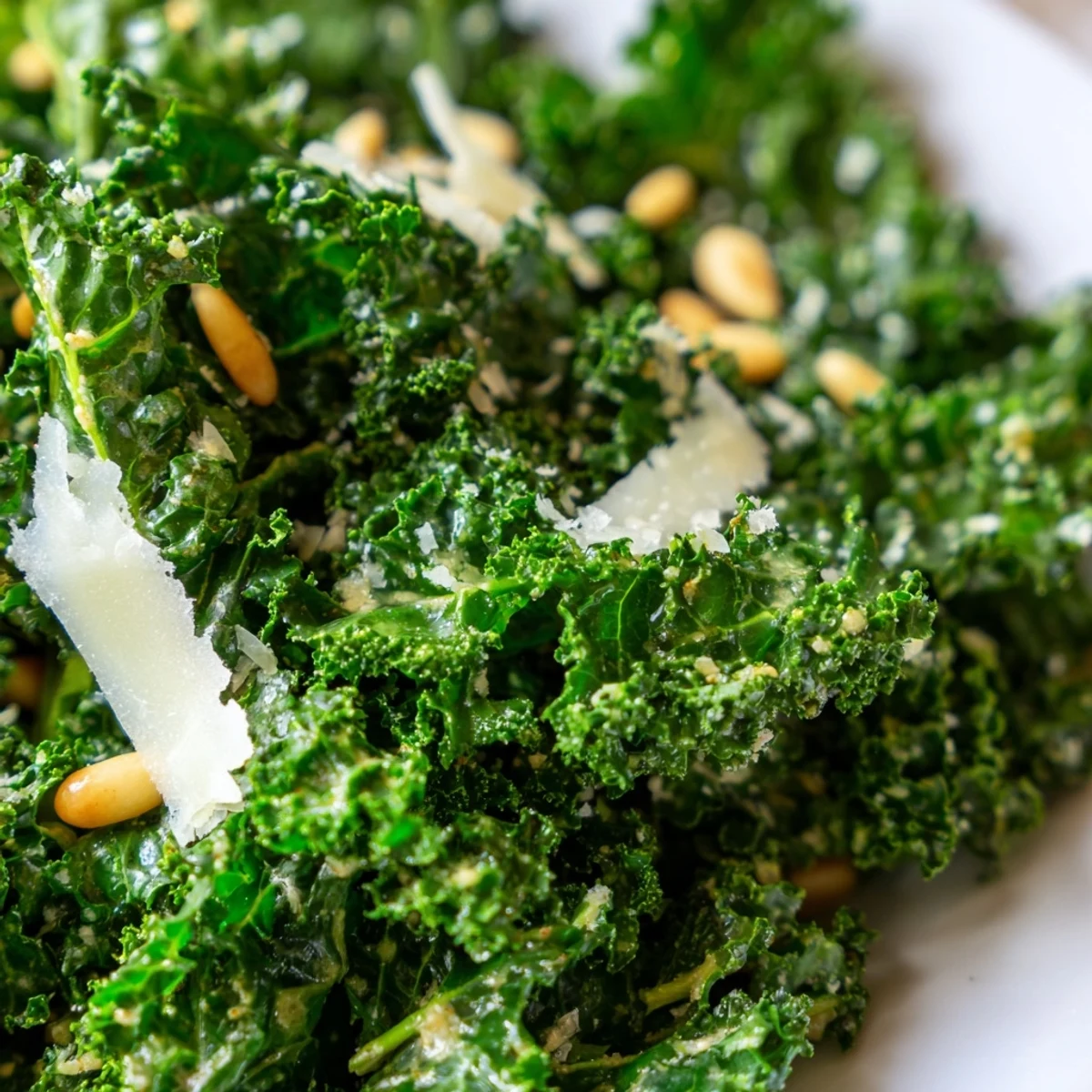Tender massaged kale leaves coated in zesty garlic lemon Parmesan dressing beautifully