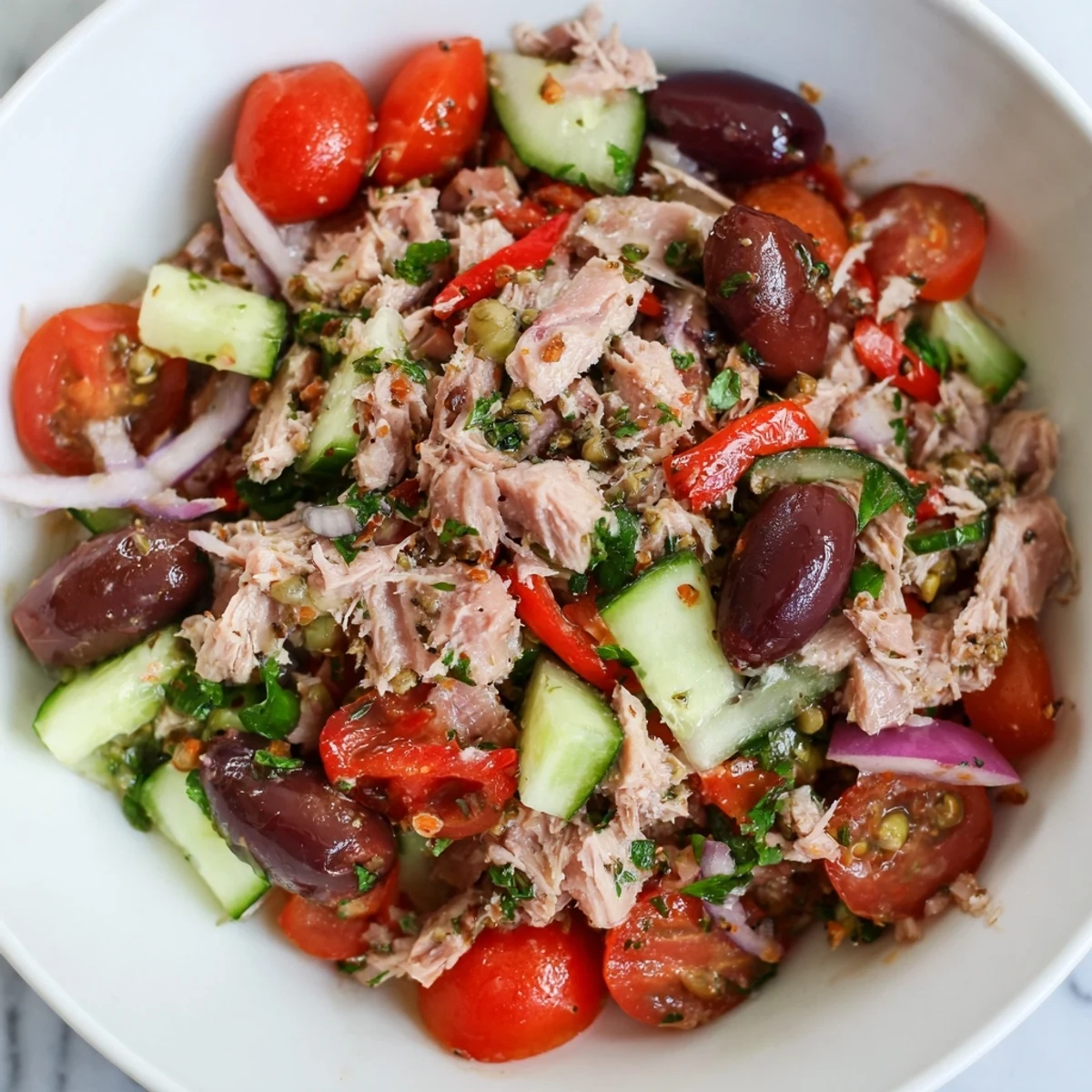 Mediterranean tuna salad served in a rustic bowl with fresh parsley and lemon.
