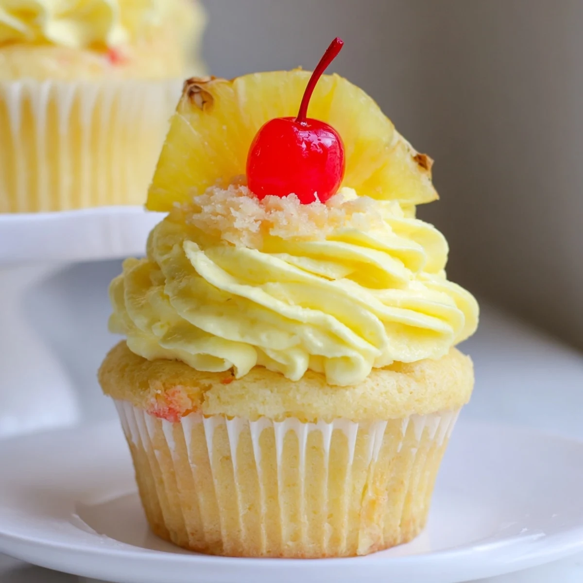 Dole Whip Cupcakes Recipe: fluffy pineapple cupcakes topped with creamy swirl