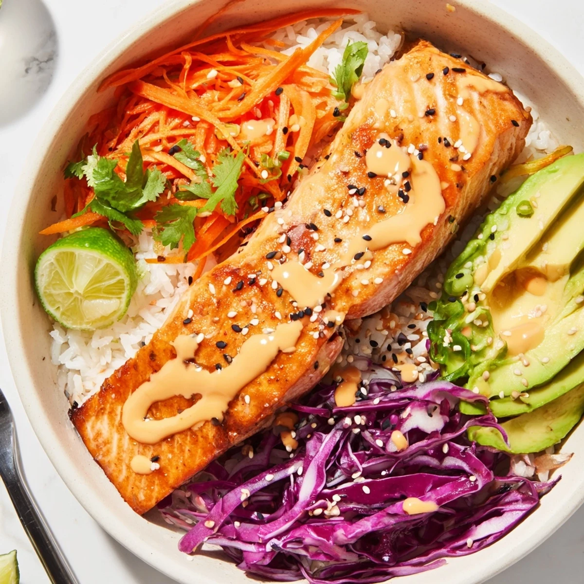 Family-style Bang Bang Salmon Bowls Recipe served warm, avocado slices, sesame seeds