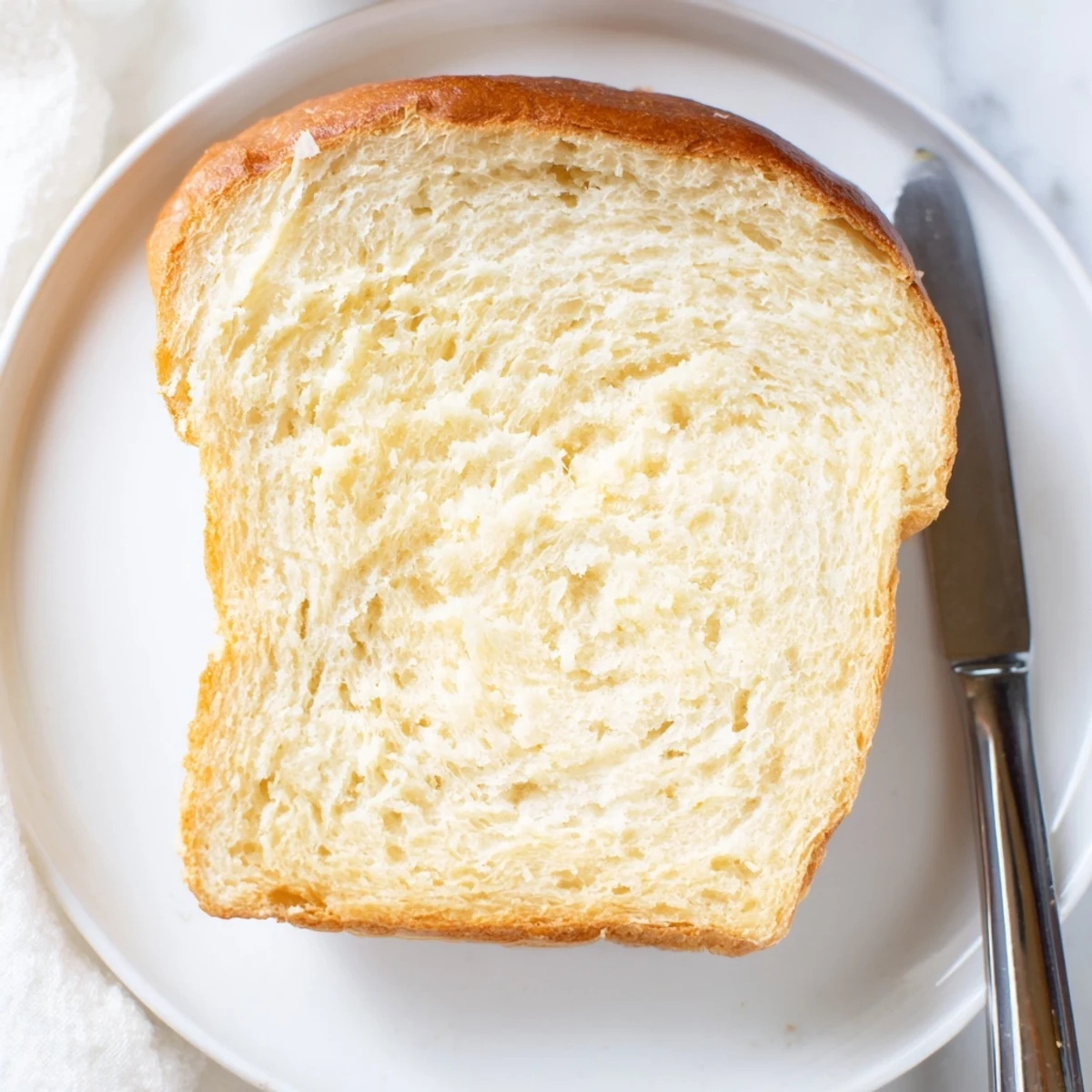 Sliced Amish white bread revealing fluffy white crumb, ideal for toasting or morning breakfast