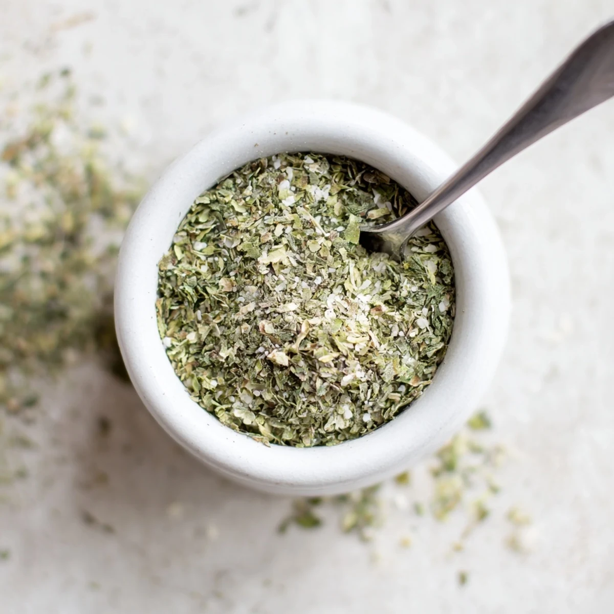Spoonful of Dehydrated Tzatziki Seasoning Mix over grilled chicken for tangy finish