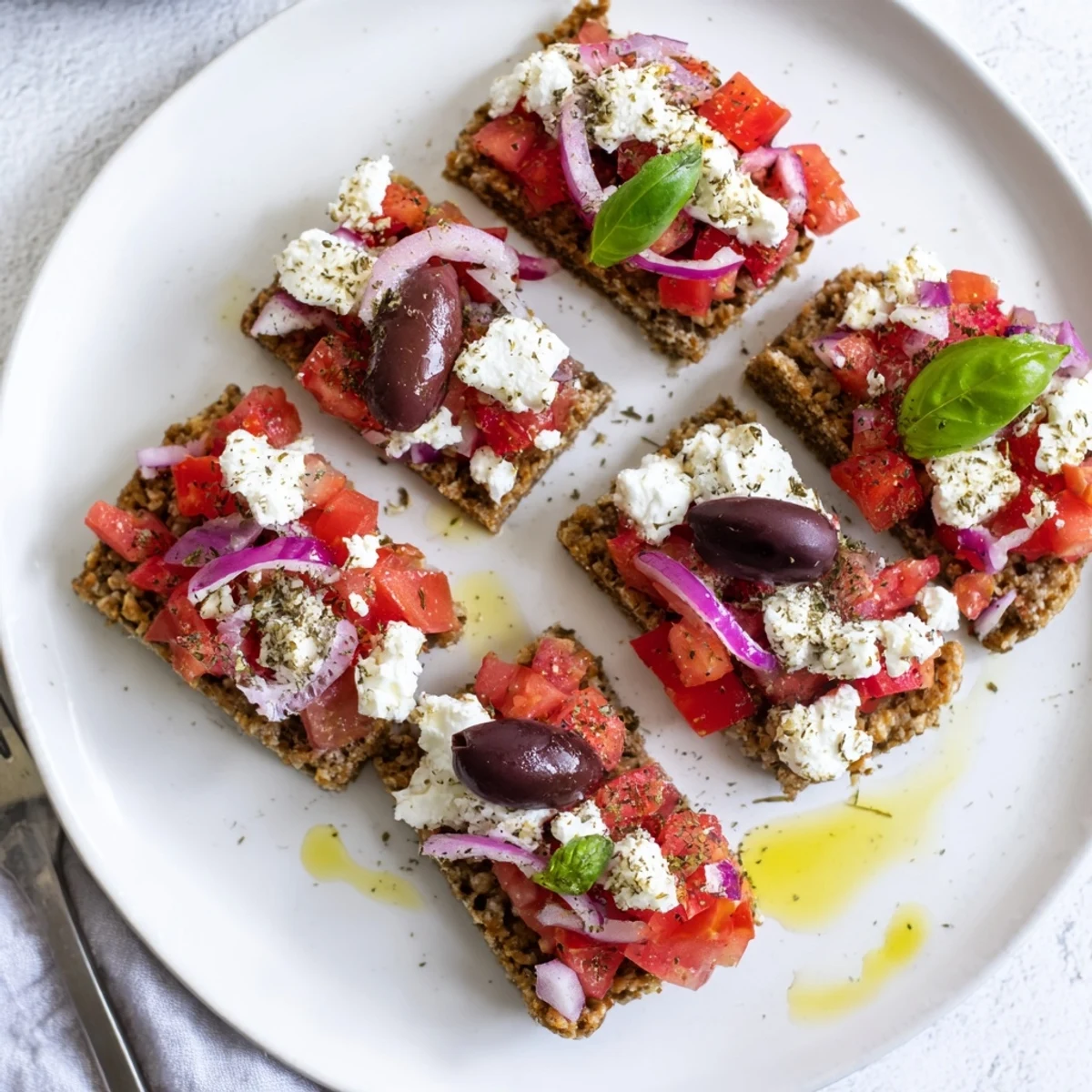 Golden crunchy rusks loaded with creamy feta cheese, diced tomatoes, and olive oil