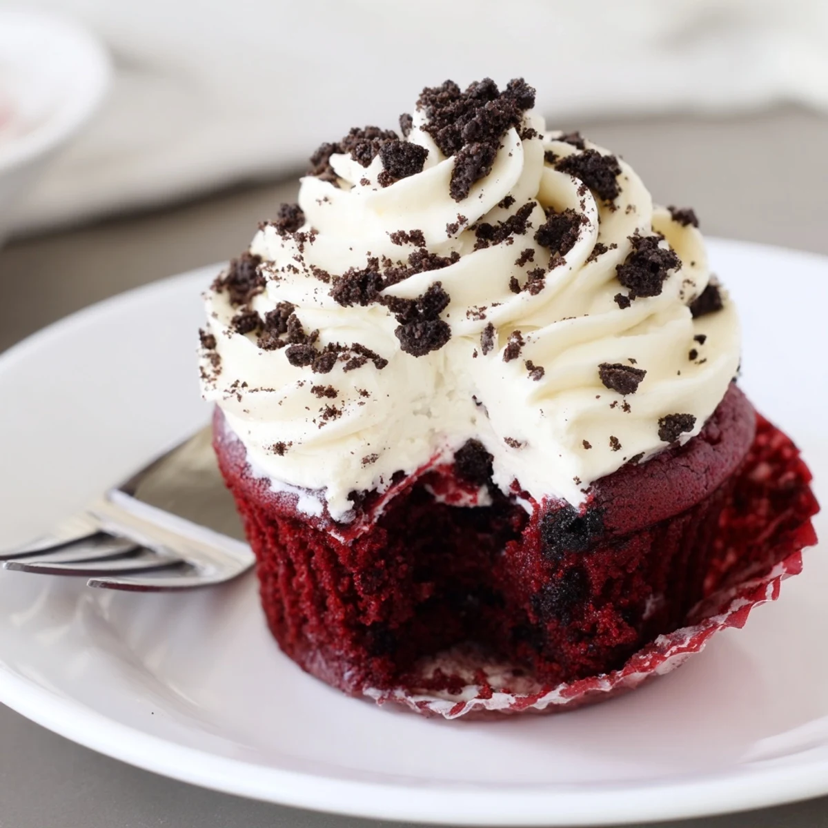 Freshly baked Red Velvet Oreo Cupcakes with rich crimson batter and pillowy Oreo cream cheese frosting