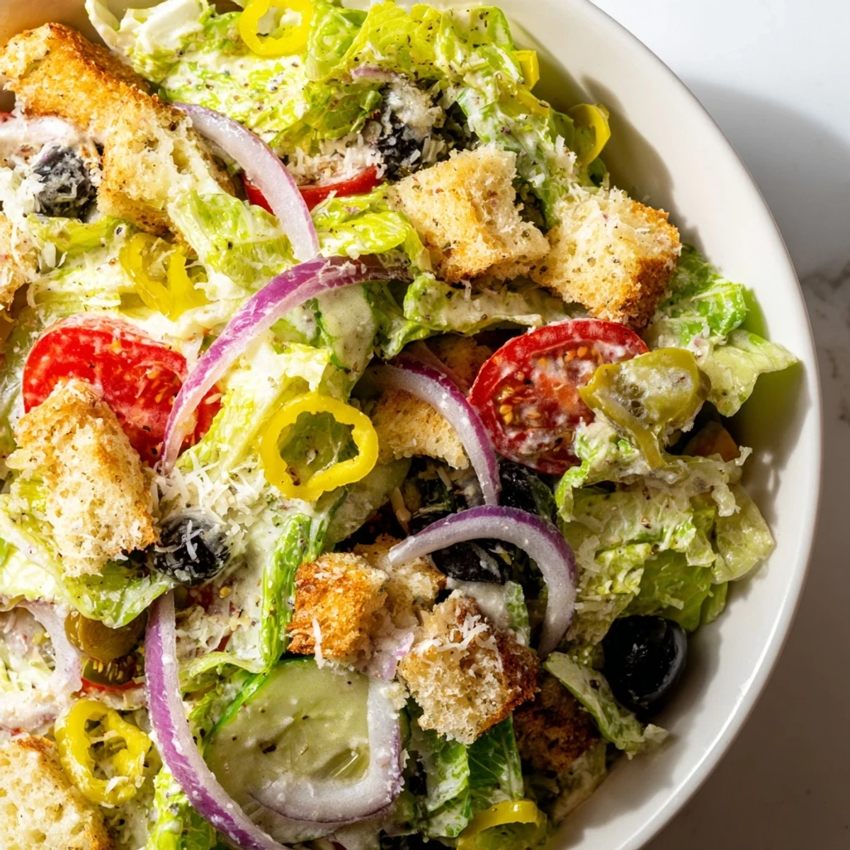 Crisp Olive Garden salad tossed in creamy Italian dressing with crunchy croutons and fresh vegetables.