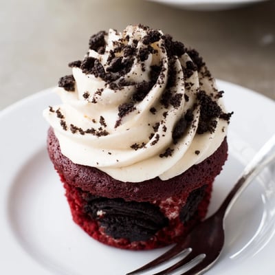 Soft Red Velvet Oreo Cupcakes with swirls of tangy cream cheese frosting and crushed cookies