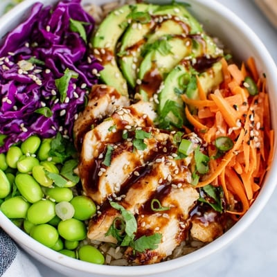 Golden seared chicken strips atop a vibrant Asian Inspired Chicken Power Bowl